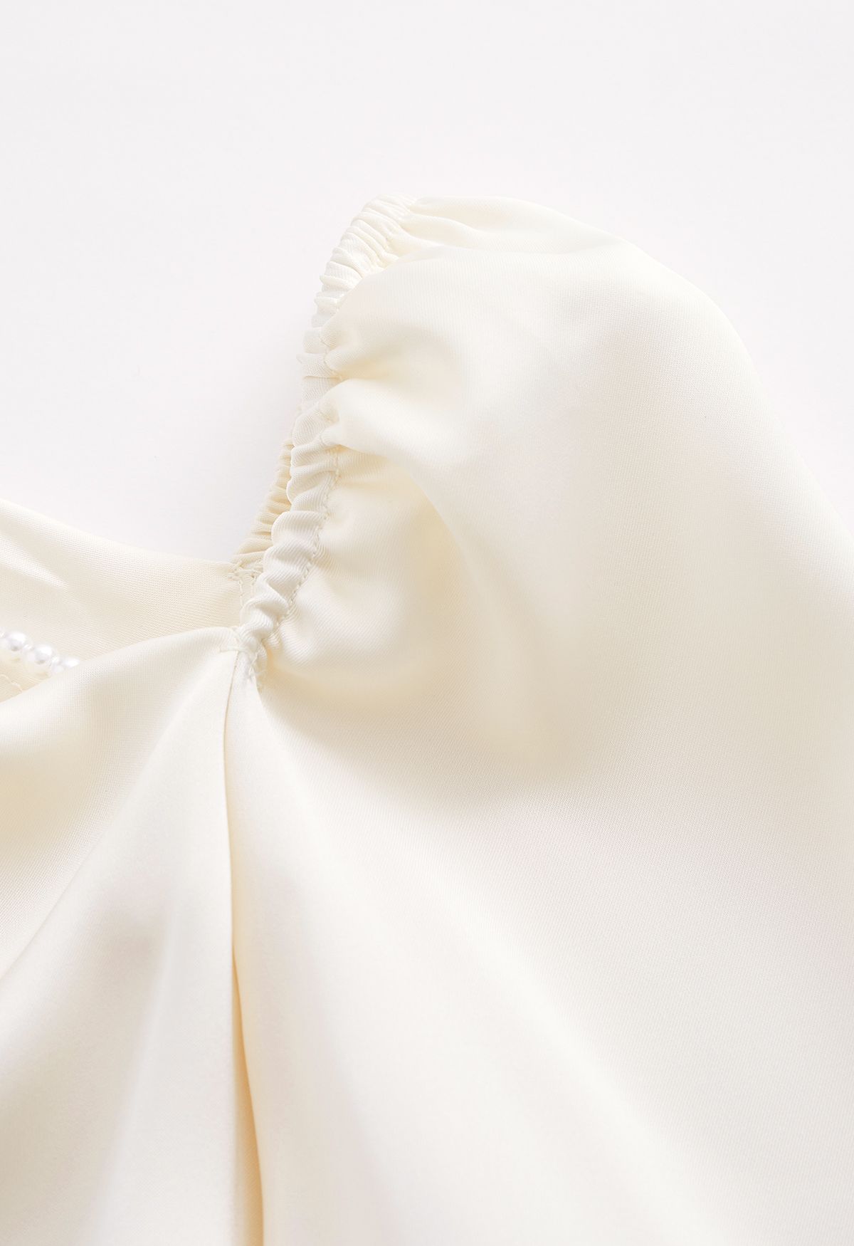 Oblique Neckline Pearly Chain Satin Top in Cream