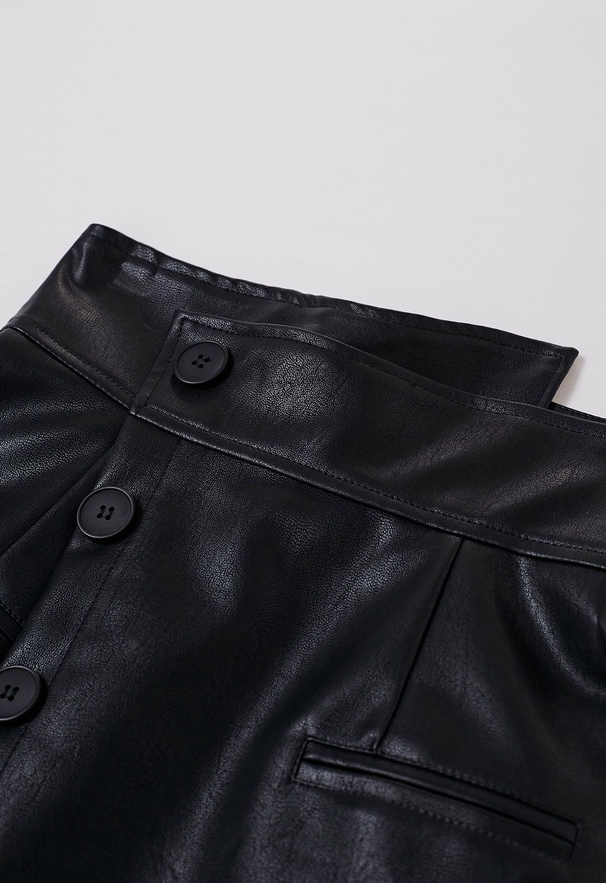 Faux Leather Asymmetric Buttoned Flap Mini Skirt in Black