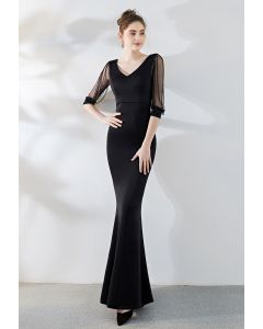 فستان بأكمام شبكية مطرزة بالخرز باللون الأسود